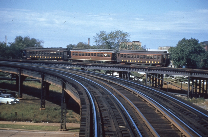 #23 - A three-car wood test train is on the connecting ramp about to descend to ground level. Where did they find the open-platform middle car? Perhaps it was borrowed from Ravenswood. This would be in 1953, before September 20. Answer: September 20, 1953 (Photo by Ray DeGroote)