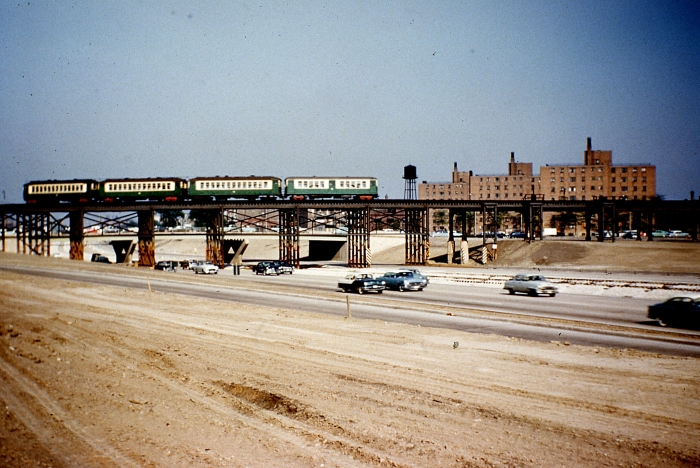 #22 - A train of westbound 4000s has ascended the ramp from the last grade crossing at California and is crossing the unlandscaped expressway to join the old Garfield Park "L" structure near Sacramento Blvd. Answer: May 25, 1956 (Photo by Charles Able)