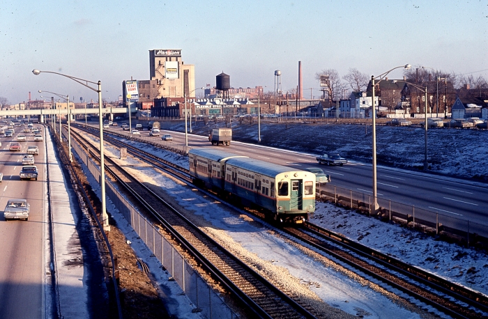 #7 - The Garfield Park "L" is but a memory. Here we see an eastbound Congress "A" train, consisting a later 6000s cars with curved doors, probably taken from the Cicero Avenue overpass with the Belt Railway overpass in the background. This must be late 50s or early 60s, with the vulgar styling of Detroit-made cars in evidence. Answer: Congress expressway at Cicero on December 27, 1963. (Photographer unknown)
