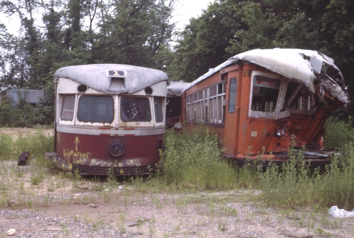 Even in the modern era, not all historic cars can be saved. Here is SEPTA "Bullet" car 201 and some Strafford cars at a scrap dealer in New Jersy in June, 1987. (Author's collection)