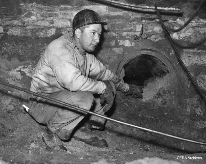 February 1, 1940 - "Mike Sunta, 4044 Montgomery, subway worker looking at the old tube where the street car cables traveled through." (More likely, these were tubes related to the cable car system that preceded streetcars.)