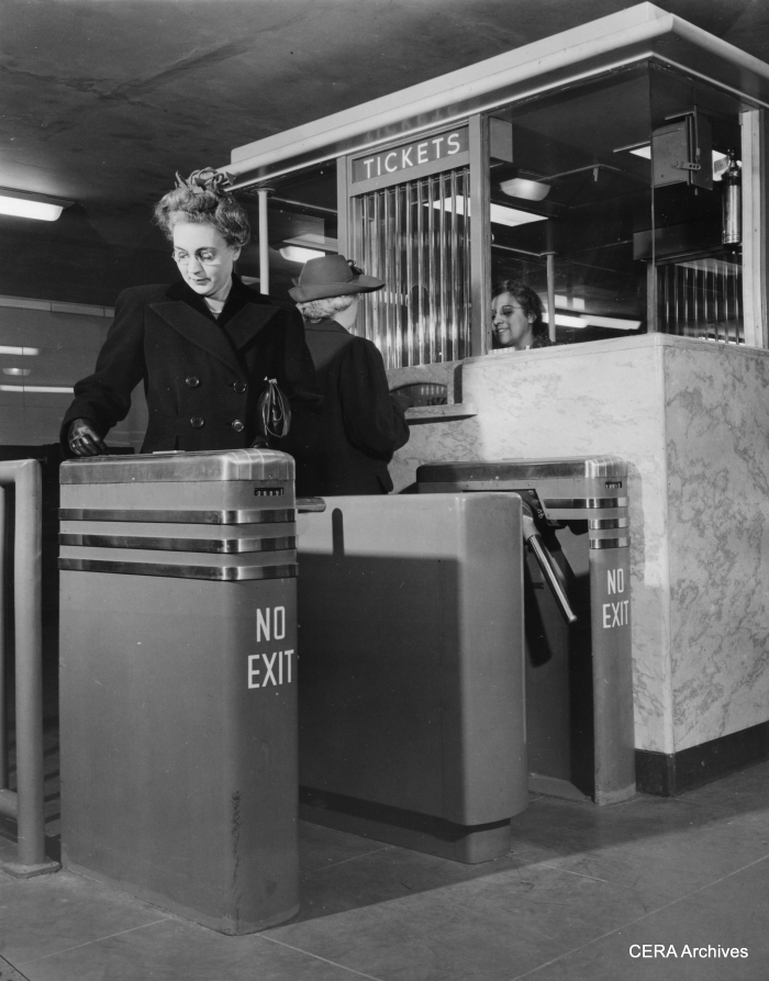 October 21, 1943 - "The stile at left operates with a dime, while the ticket seller turns the one at the right from her booth for passengers using transfers or those requiring change."