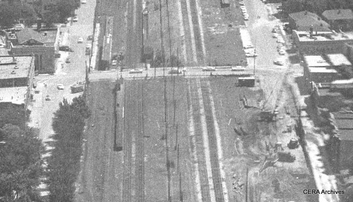 A close-up view showing the CTA's temporary station at Oak Park avenue on July 25, 1957. The B&O freight tracks are at right. Everything here is still at ground level.The CTA tracks have been moved to the north. Note that the eastbound and westbound platforms are on opposite sides of Oak Park avenue. The highway would not open in this area until more than three years later. (Photo by Burley)