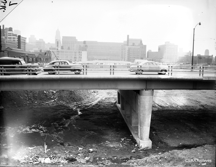 Some of the earliest work on the expressway involved digging out and building overpasses. That way, roads could be diverted around the affected area. (Photographer unknown)