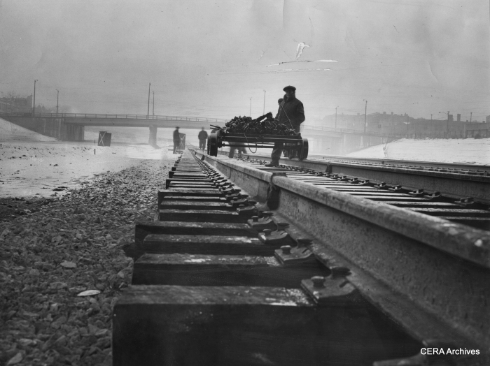 February 9, 1956 - "Congress at expressway about 2900 west. Workmen brave the bad weather to continue completion of rails on the Congress st expressway. They fasten down rails with brackets and spikes." (Photo by Larry Nocerino)