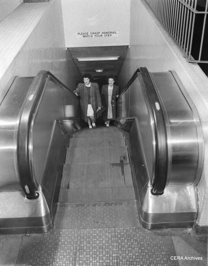 October 21, 1943 - "Electric escalators, which can be operated in either direction depending on rush hour needs, are used to speed moving of passengers between train levels and station levels, just below the street surface. Stairways run parallel to the escalators, while walls of passage ways and station levels are of tile." (Photographer unknown)