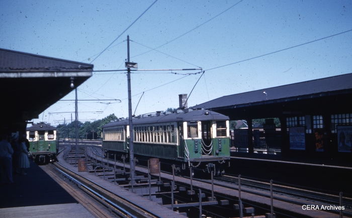 In this July 5, 1960 view, 4000s are switching between third rail and overhead wire. The westbound train at right prepares to descend the ramp to ground-level operation. By the time the new embankment alignment opened in October 1962, CTA had moved the power changeover point west to the Central Avenue station. (Unknown Photographer)