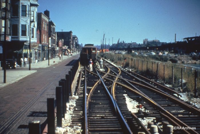 From the sign on the wooden "L" car, this must be a CTA test train on the temporary Van Buren Street trackage, just prior to the beginning of service in September 1953. Streetcar tracks are still visible in Van Buren Street. (Photographer unknown)