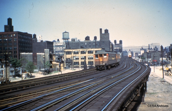 A two-car train of CTA woods heads west on the Garfield "L", somewhere east of Marshfield Junction. (Photographer unknown)