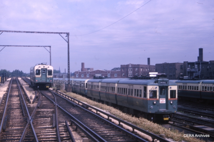 A CTA single car unit in Evanston service heads southbound approaching the Howard terminal in this July 17, 1965 view. One of the 51-54 series articulated cars used on the Skokie Swift is parked in the yard. (CERA Archives)
