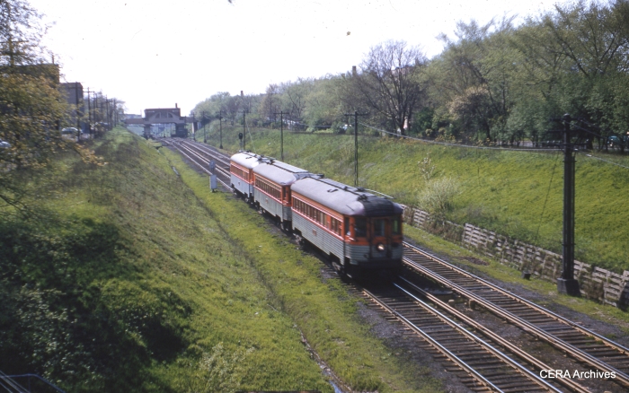 A three-car train of North Shore "Silverliners" in the Evanston open cut in May 1955. (CERA Archives)