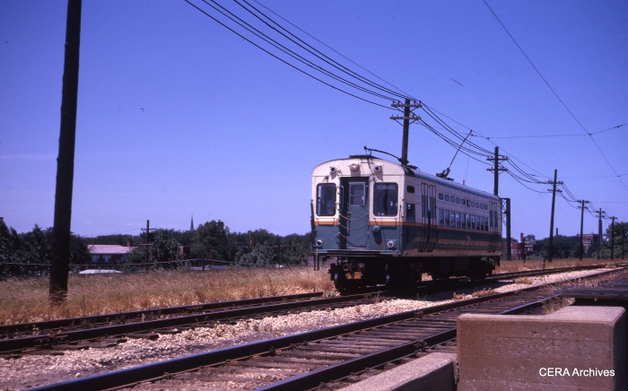 From 1961 to 1973, CTA operated PCC single car units in Evanston service with trolley poles. Some of these cars were eventually adapted for use in Skokie service. Here we are opposite Calvery cemetery. (CERA Archives)