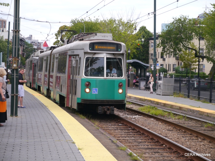 A Green Line train, led by a Type 7 car, makes its first stop after emerging from the subway tunnel.